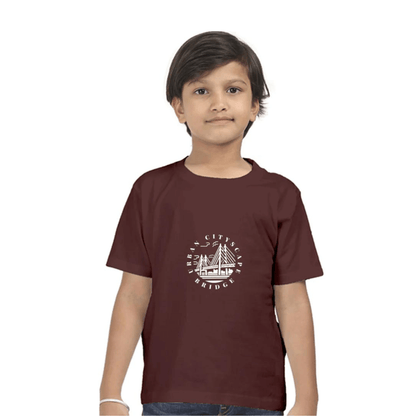 Child wearing Urban City Kids Tshirt in maroon with a cityscape bridge design