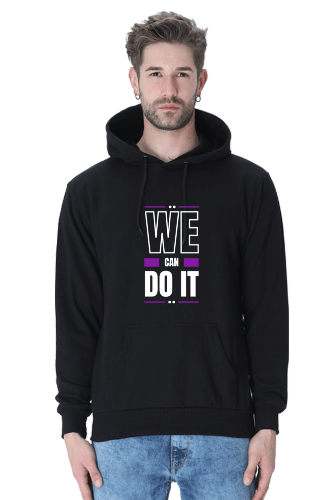 Man wearing a black hooded sweatshirt with the text "WE CAN DO IT" in bold colors, perfect for winter style.