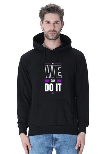 Man wearing a black hooded sweatshirt with the text "WE CAN DO IT" in bold colors, perfect for winter style.