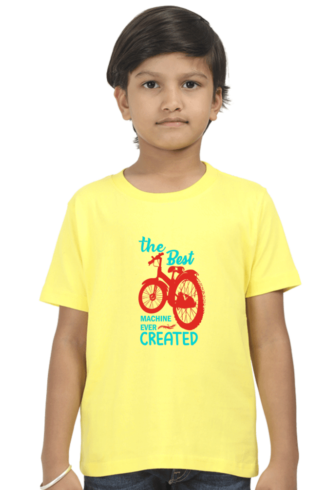 Boy wearing yellow The Best Machine Ever Created Kids Round Neck T-shirt with bike graphic illustration.