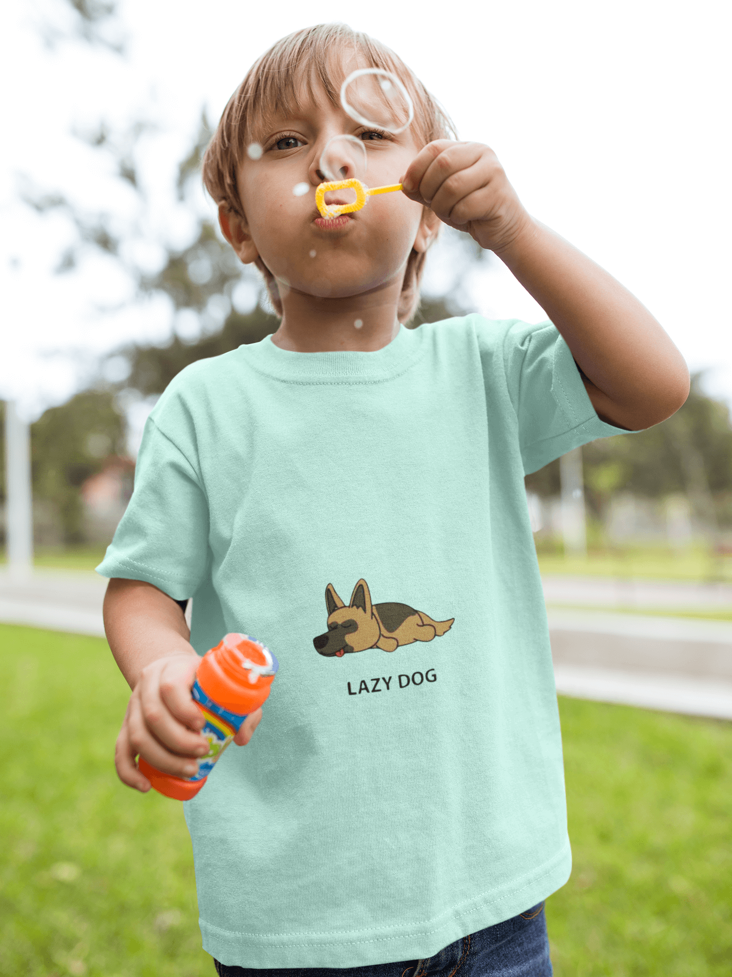 Child blowing bubbles while wearing a Lazy Dog Kids T-Shirt made from 180 GSM super combed bio-washed fabric.