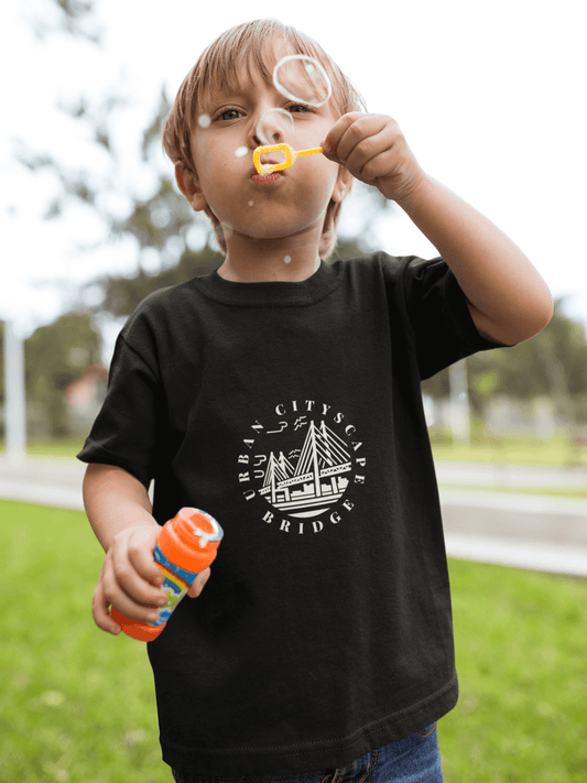 Child wearing Urban City Kids T-shirt blowing bubbles outdoors