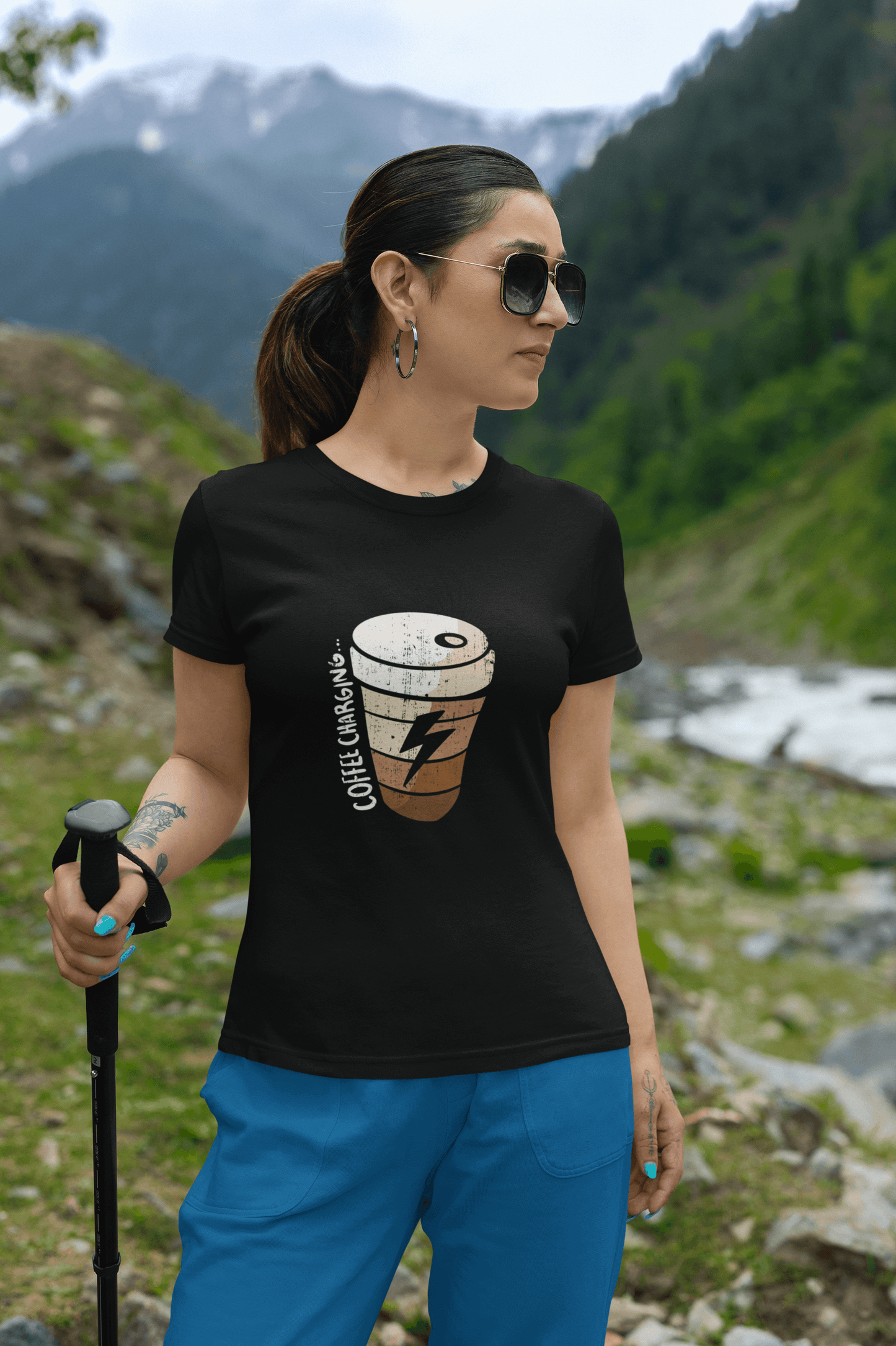 Woman wearing Coffee Charging Round Neck Unisex T-Shirt in mountain scenery