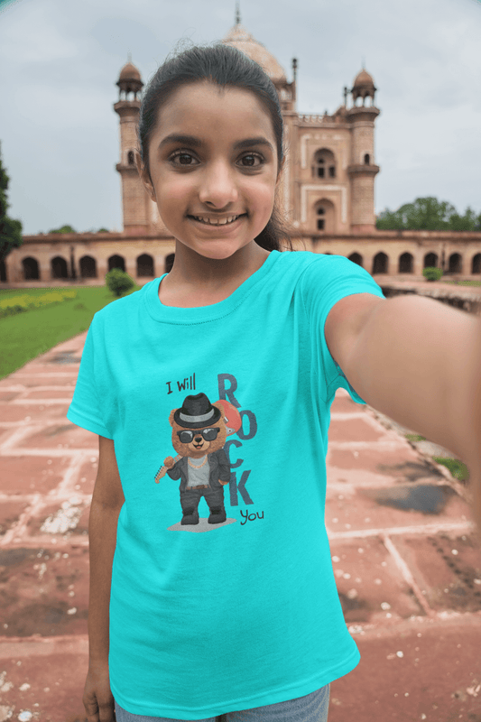 Girl wearing "I Will Rock You" kids round neck t-shirt in front of historic building