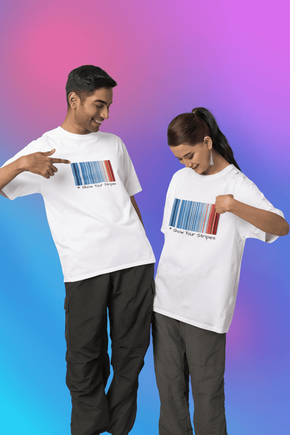 Two people wearing "Show Your Stripes" t-shirts, featuring warming stripe graphics depicting temperature changes in India.